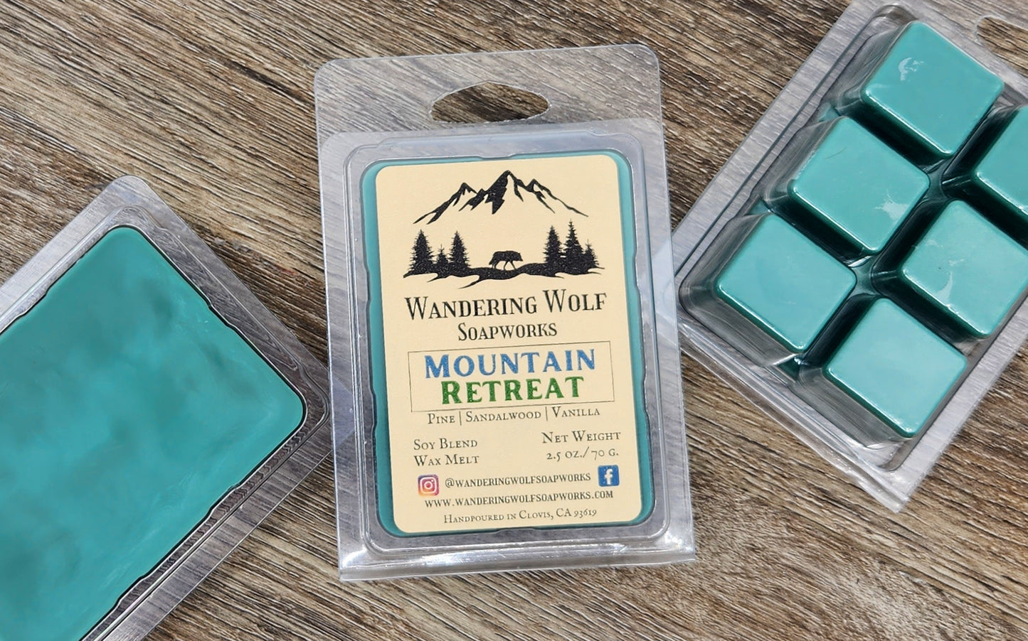 A package of 'Wandering Wolf Soapworks' Mountain Retreat wax melts, with a green and brown color scheme, displayed in a clear plastic 6 cavity clamshell.