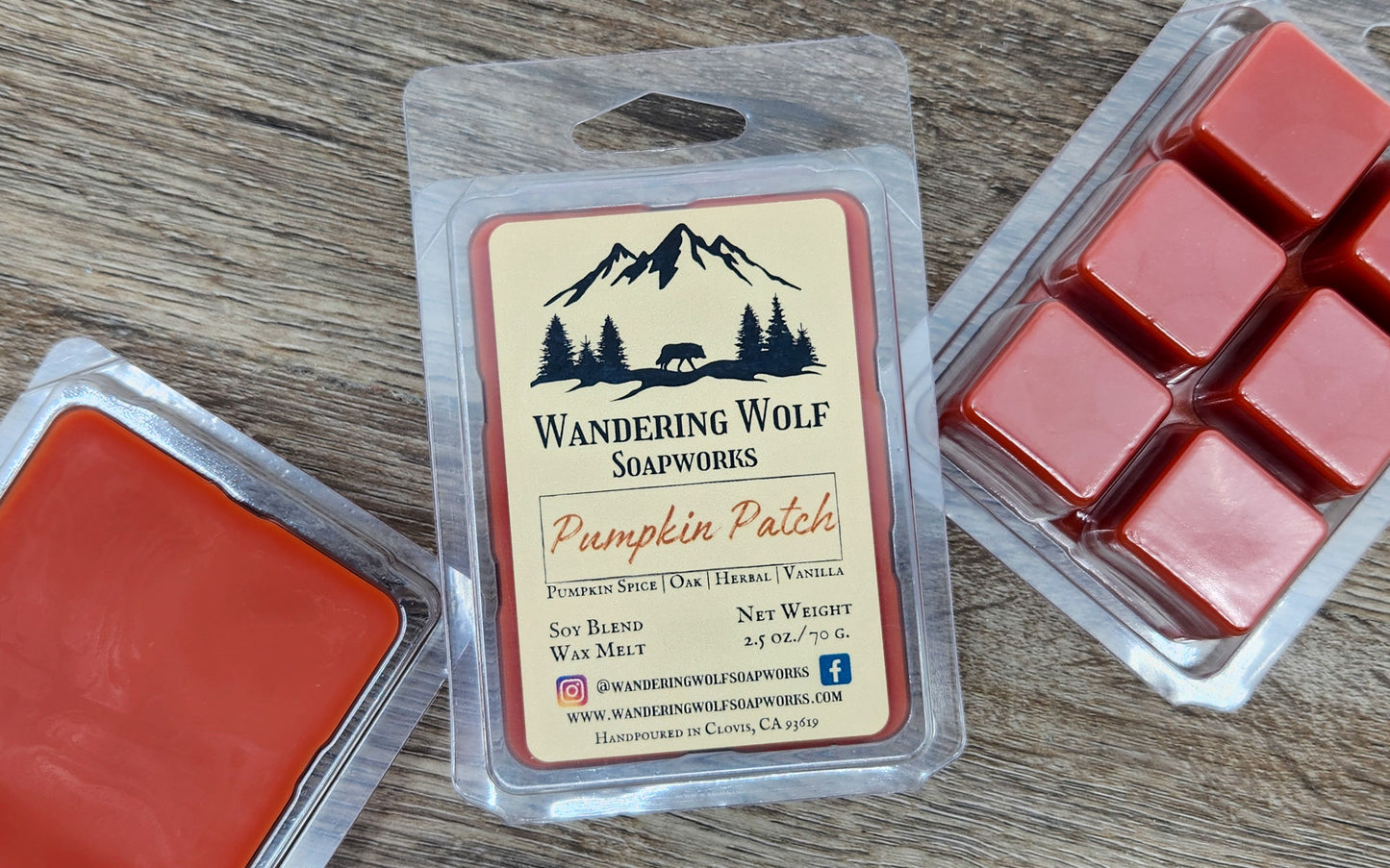 Wax melts in a packaging labeled 'Wandering Wolf Soapworks' on a wooden surface