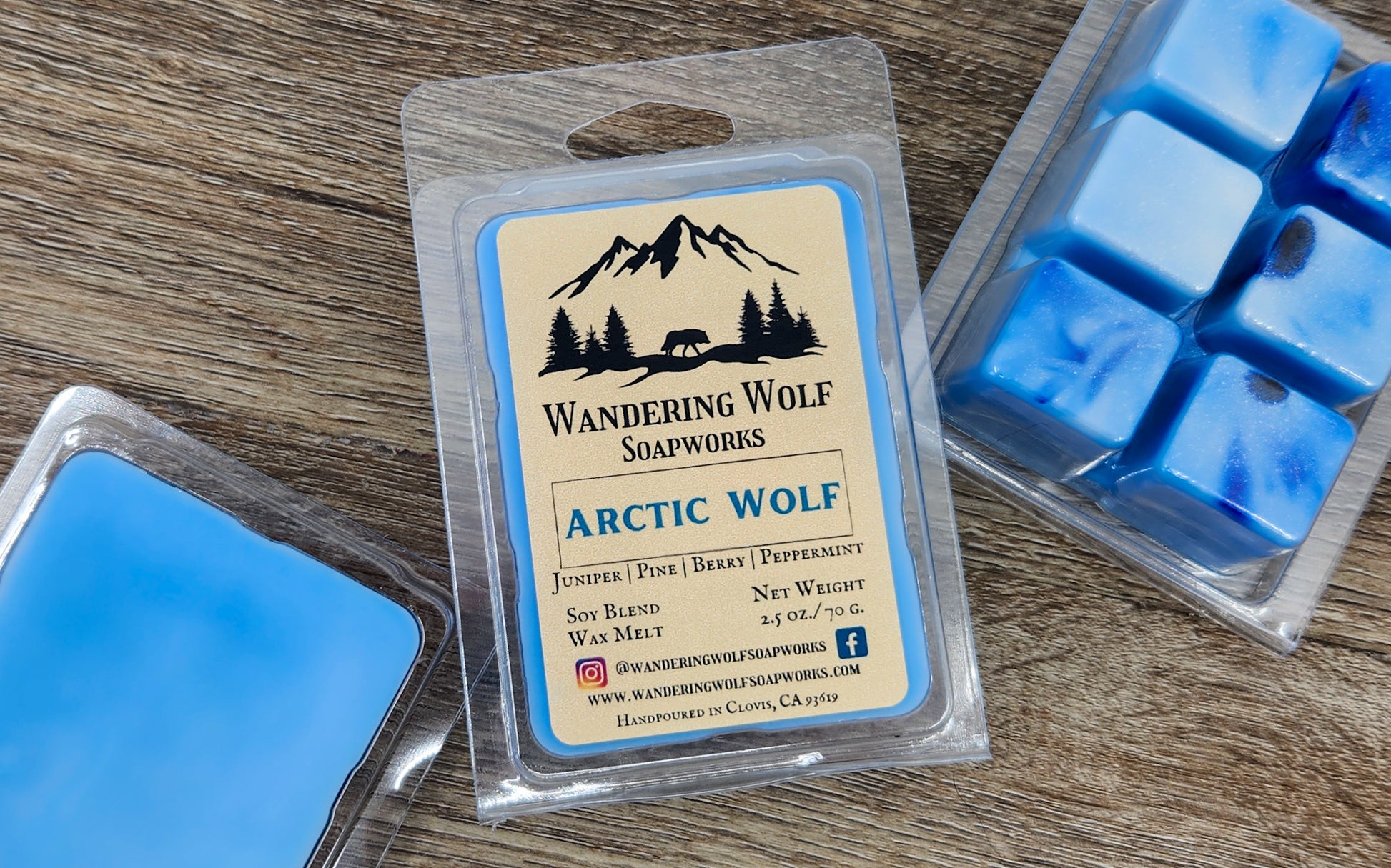 A package of Arctic Wolf wax melts by Wandering Wolf Soapworks, with visible blue wax cubes and a label that includes the product name and description.