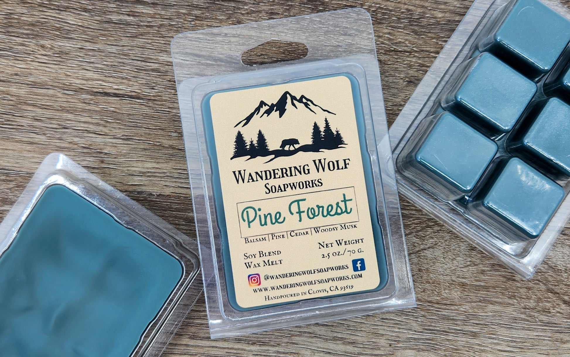 A package of Wandering Wolf Soapworks Pine Forest wax melts, with the product visible through a clear plastic clamshell. The label on the package has the brand name, product title, and additional information.