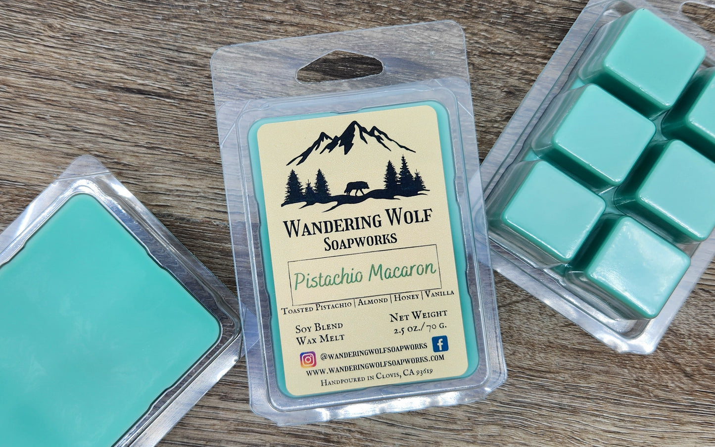 Wax melts in a Wandering Wolf Soapworks packaging on a wooden surface